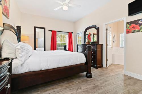 a bedroom with a large bed and a bathroom at Cristina's Tropical Villa/ Just minutes from Disney! in Kissimmee