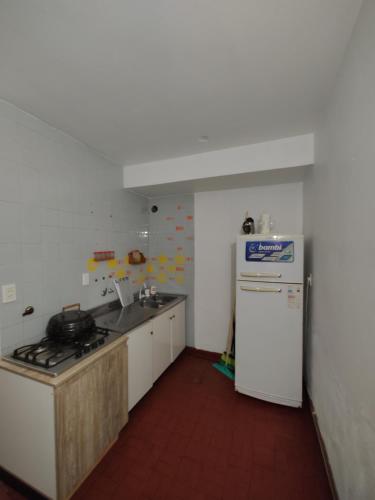 a kitchen with a stove and a refrigerator in it at Edificio Engwald in Eldorado