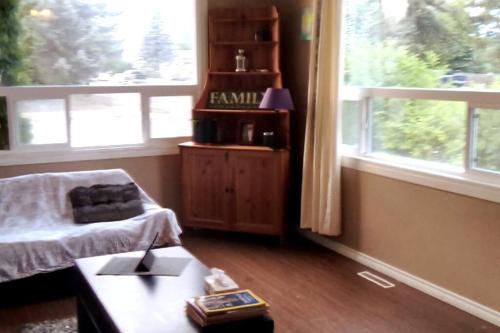a living room with a coffee table and a window at Family and Pet friendly home in Cold Lake