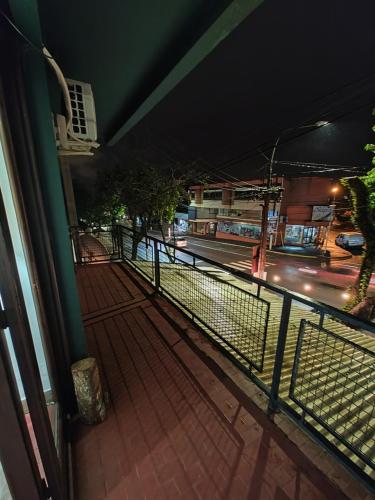 a balcony with a fence and a street at night at Edificio Engwald in Eldorado