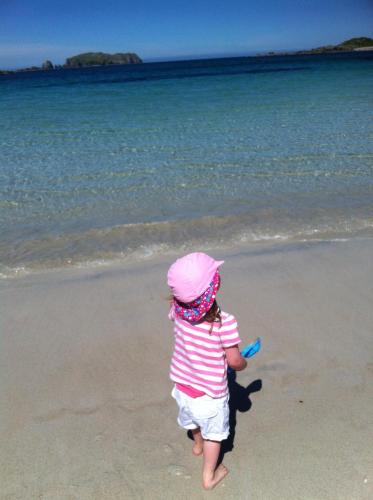 a little girl walking on the beach at Tigh-na-Greine in Carloway