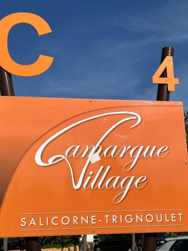 un panneau orange pour un village d'avion avec un panneau pour une aphrinephrinephrinephrine dans l'établissement Appartement Camargue Village, au Grau-du-Roi