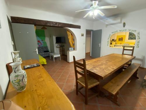 - une salle à manger avec une table en bois et un canapé dans l'établissement Maison du cèdre, à Cavalaire-sur-Mer