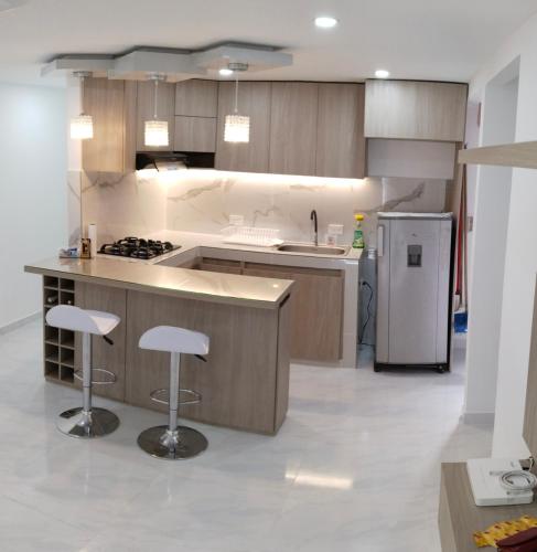 a kitchen with a sink and a stove top oven at Hermoso Apartamento en Neiva in Neiva