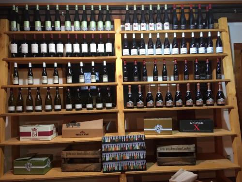 a bunch of wine bottles on a shelf at Johanneshof Gästehaus in Hockenheim