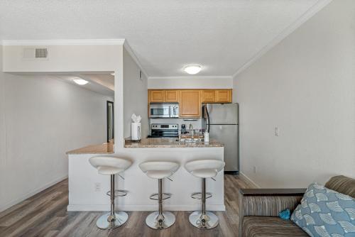 a kitchen with a bar in a living room at Wake up to Ocean Views from your private balcony in Tampa
