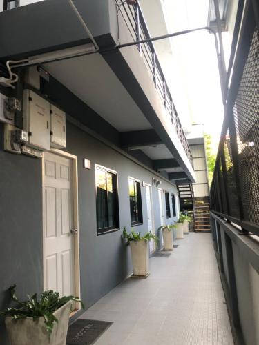 an empty hallway of a building with potted plants at SP Home BangSaen in Bangsaen