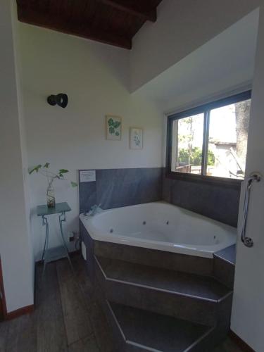 a bathroom with a large tub and a window at Playa Bonita Mar Azul in Mar Azul