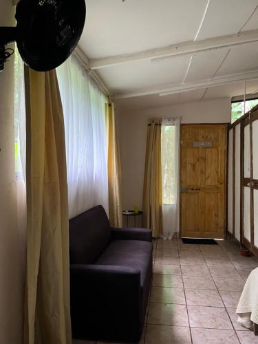 a living room with a couch and a window at Chilamate Rainforest Eco Retreat in Puerto Viejo