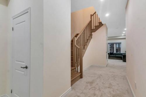 a hallway with a staircase in a house at Treasure in Brant - 4 Bedroom Detached House in Paris