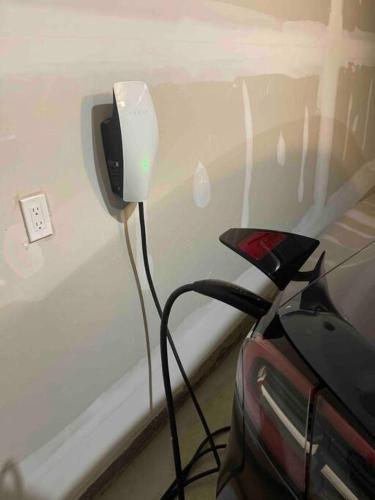 a car plugged into a lightswitch on a wall at Treasure in Brant - 4 Bedroom Detached House in Paris