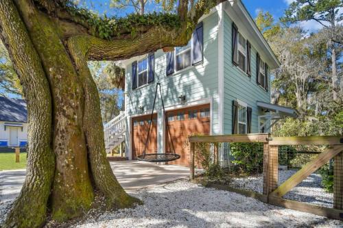 a house with a tree in front of it at The Bluffton Village Home - 5 BR in Old Town w Carriage Home in Bluffton