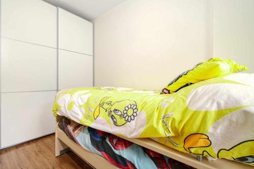 a bedroom with a bed with a yellow blanket at Ideal familias zona infantil y vistas a pistas in Candanchú