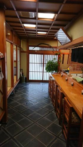 a large room with a long table and chairs at Travel Inn Ikuta in Minabe