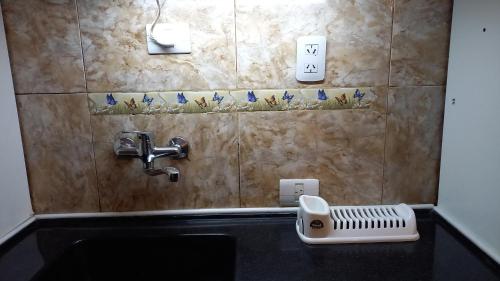 a bathroom sink with a faucet and a soap dispenser at Brisa del Cielo in Salta
