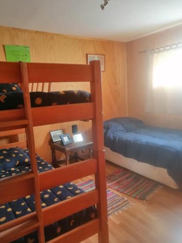 a bedroom with two bunk beds and a table at Casa Familiar Santo Domingo in El Convento