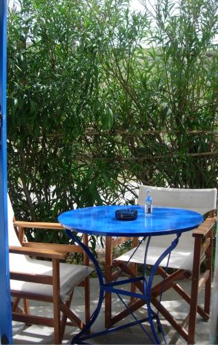 a blue table and chairs on a patio at Marathi Apartments in Maráthion