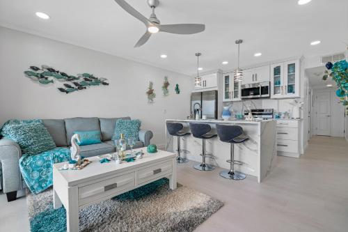 a living room with a couch and a kitchen at Welcome to Sea Forever Balcony with ocean views! in Tampa