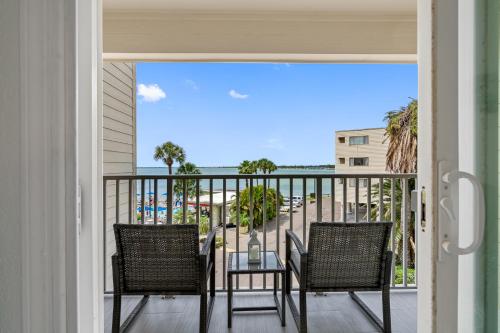 a balcony with two chairs and a table with a view at Welcome to Sea Forever Balcony with ocean views! in Tampa
