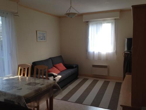 un salon avec un canapé et une table dans l'établissement Studio calme avec balcon près centre-ville et plage, parking privé - FR-1-712-1, à Villers-sur-Mer