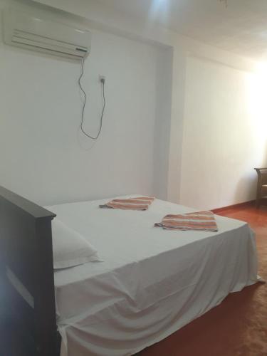 a white bed with two towels on top of it at Nature guesthous in Midigama