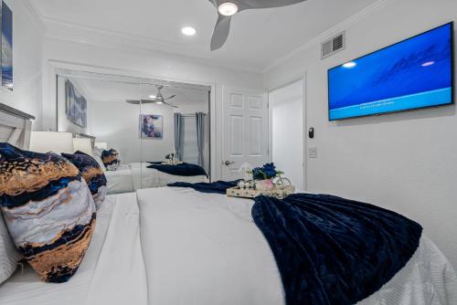 a bedroom with a large bed with a tv on the wall at Bay Views from your Balcony Beach Resort Tampa in Tampa