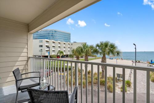 a balcony with chairs and a view of the beach at Bay Views from your Balcony Beach Resort Tampa in Tampa