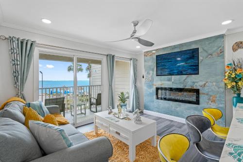 a living room with a couch and a fireplace at Bay Views from your Balcony Beach Resort Tampa in Tampa