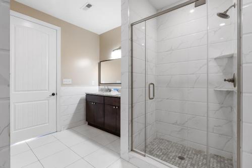 a bathroom with a shower with a glass door at Bali Bay 403 OV Myrtle Beach Hotel Room in Myrtle Beach