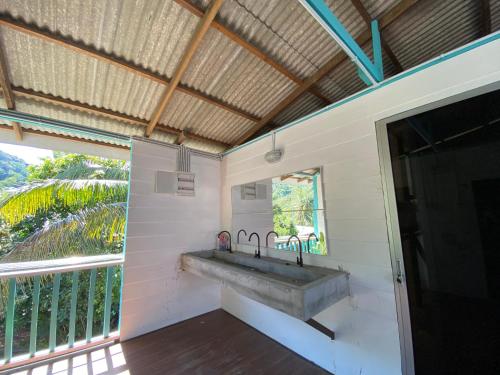 a bathroom with a sink and a large window at Dormitory Pondok in Tioman Island