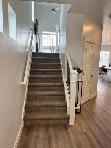 a staircase in a house with a stair case at NEW 4-bed 4-bath Stylish House with Mountain View and 2 garages in Lehi
