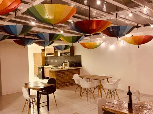 a room with tables and chairs and colorful lights at CASA CREAZZO 62 - Movistar Arena in Bogotá