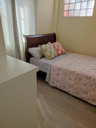 a small bedroom with a bed and a window at Belle Cove in Gros Islet