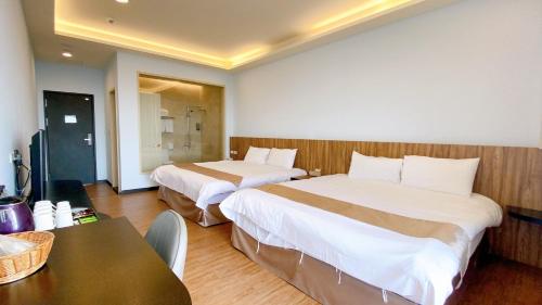 Postel nebo postele na pokoji v ubytování 花蓮星晟棧飯店Starry Inn近太平洋新城車站