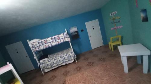a childs room with a crib and a table at Castaways Villa in Duncans