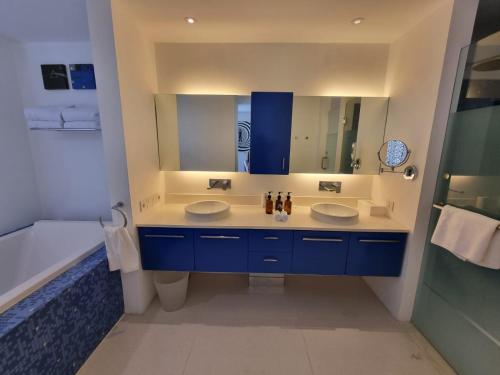a bathroom with two sinks and a large mirror at Chill Hotel Seminyak in Seminyak