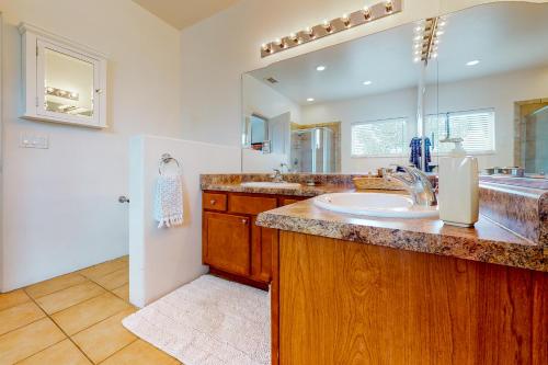 a bathroom with a sink and a large mirror at Casa Vistoso in Santa Fe