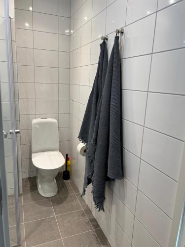 a bathroom with a toilet and towels hanging on a wall at TunnebergaBoB in Jonstorp
