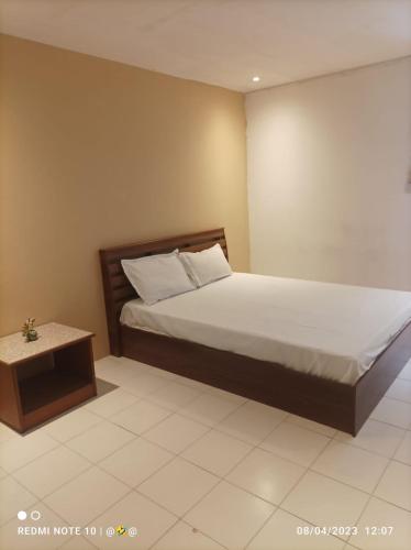 a bedroom with a bed and a side table at Green Paradise in Pattaya North