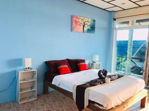 una camera da letto con due letti e una parete blu di Rock sand Resort a Trat