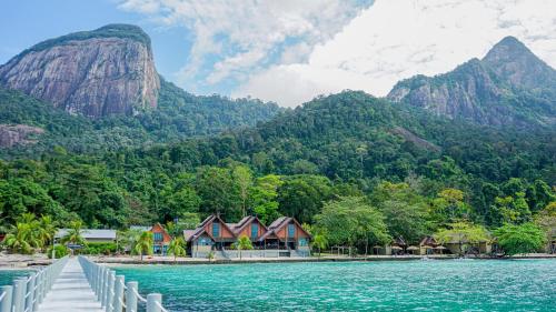a row of houses on the shore of a body of water at Tunamaya Beach & Spa Resort Tioman Island in Tioman Island