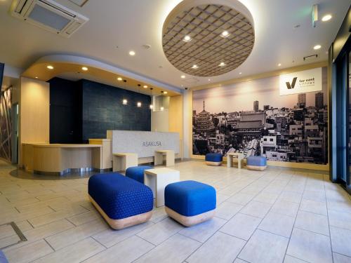 a lobby with tables and blue stools in a building at Far East Village Hotel Tokyo, Asakusa in Tokyo