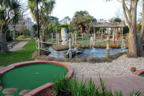a water park with a green pond and a water slide at Tor Dean Guest House in Torquay