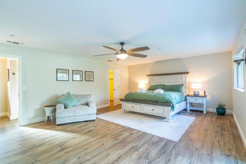 a bedroom with a bed and a couch and a ceiling fan at Mystic Mountain Villa, 14 miles from Yosemite in Oakhurst
