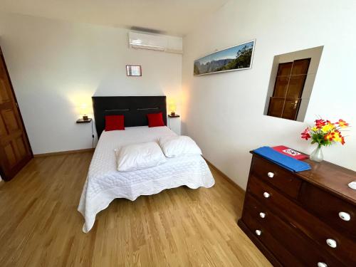 a bedroom with a large bed and a dresser at Le Quindio in Bras-Panon