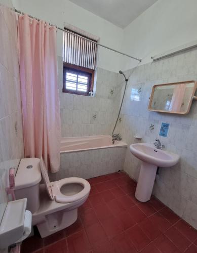 a bathroom with a toilet and a sink and a tub at Apartment in Colombo in Colombo