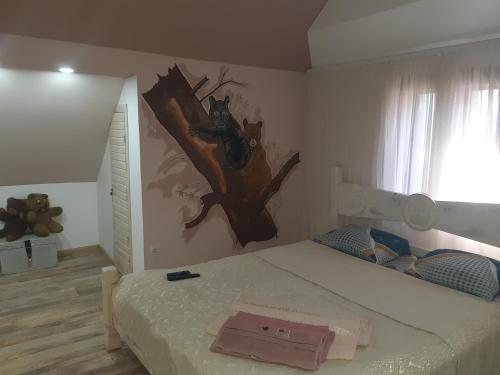 Schlafzimmer mit einem Bett mit Wandgemälde in der Unterkunft Barlig in Jaremtsche