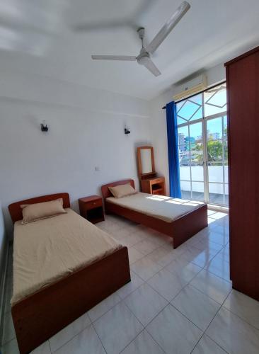 a bedroom with two beds and a window at Apartment in Colombo in Colombo
