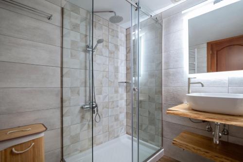 a bathroom with a glass shower and a sink at Sofita με θέα τη θάλασσα Villa Athina in Preveza