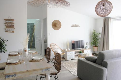 un salon avec une table et un canapé dans l'établissement Aux Quereux de Bel Air, à Andilly-les-Marais